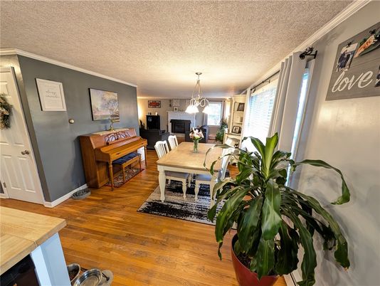 Dining room, Fireplace, Interior, Pendant Lights, Piano, Wood Texture Flooring