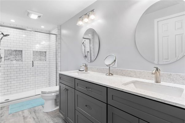 Bathroom, Dual Sink Vanities, Glass Shower, Interior, Recessed Lighting, Wood Texture Flooring