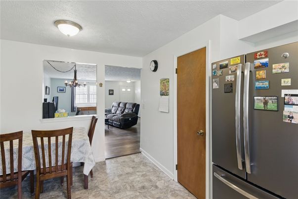 Chandelier, Dining room, Interior, Kitchen, Living room, Stainless Steel Appliances, Wood Texture Flooring