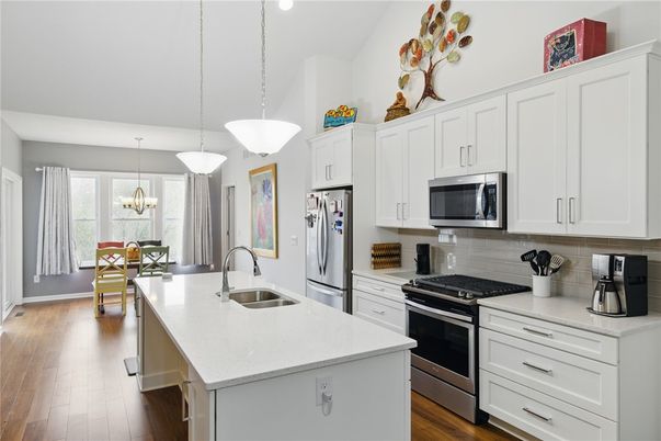Chandelier, Dining room, Interior, Kitchen, Pendant Lights, Recessed Lighting, Stainless Steel Appliances, Wood Texture Flooring