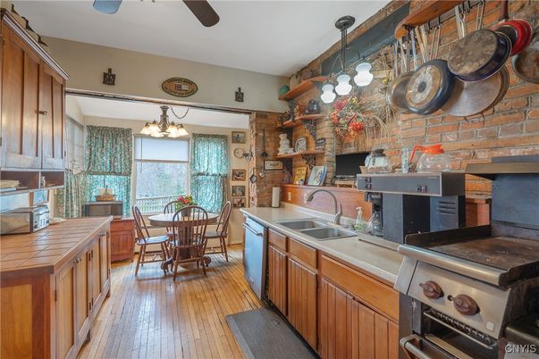 Chandelier, Dining room, Interior, Kitchen, Stone Walls, Tile Countertops, Wood Texture Flooring
