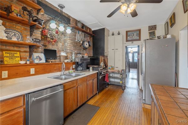 Interior, Kitchen, Pendant Lights, Stainless Steel Appliances, Stone Walls, Tile Countertops, Wood Texture Flooring