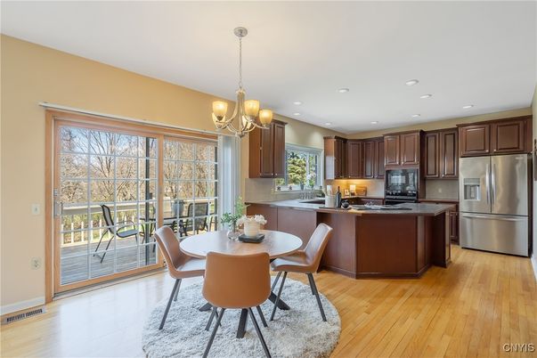 Chandelier, Dining room, Interior, Kitchen, Recessed Lighting, Stainless Steel Appliances, Wood Texture Flooring