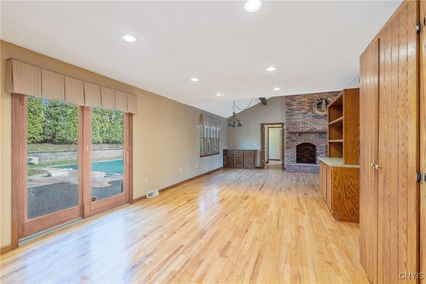 Empty room, Fireplace, Interior, Recessed Lighting, Stone Walls, Wood Texture Flooring