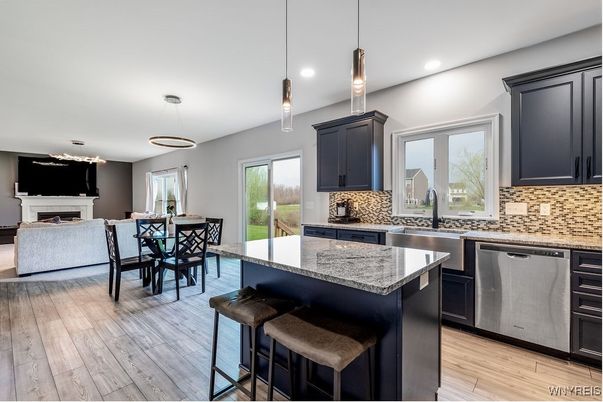 Dining room, Fireplace, Interior, Kitchen, Living room, Pendant Lights, Recessed Lighting, Stainless Steel Appliances, Wood Texture Flooring