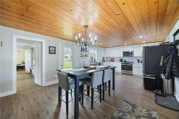 Chandelier, Dining room, Interior, Kitchen, Recessed Lighting, Stainless Steel Appliances, Wooden Ceilings, Wood Texture Flooring