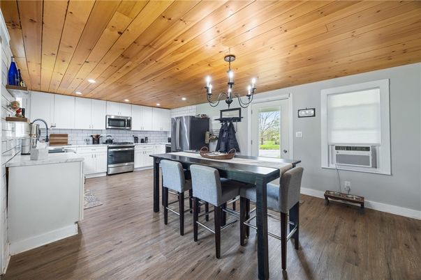 Chandelier, Dining room, Interior, Kitchen, Recessed Lighting, Stainless Steel Appliances, Wooden Ceilings, Wood Texture Flooring