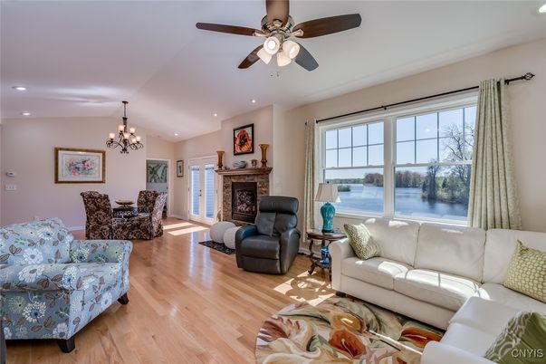 Chandelier, Dining room, Fireplace, Interior, Living room, Recessed Lighting, Water, Wood Texture Flooring