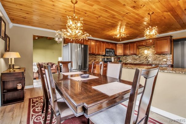 Chandelier, Dining room, Interior, Kitchen, Pendant Lights, Stainless Steel Appliances, Wooden Ceilings, Wood Texture Flooring