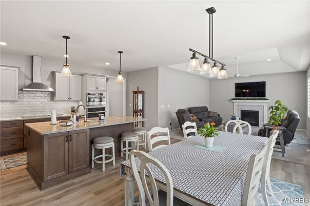 Dining room, Fireplace, Interior, Kitchen, Living room, Pendant Lights, Recessed Lighting, Stainless Steel Appliances, Wood Texture Flooring