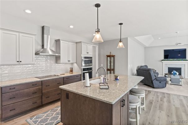 Fireplace, Interior, Kitchen, Living room, Pendant Lights, Recessed Lighting, Stainless Steel Appliances, Wood Texture Flooring