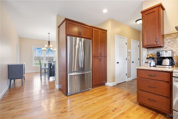 Chandelier, Dining room, Interior, Kitchen, Recessed Lighting, Stainless Steel Appliances, Wood Texture Flooring