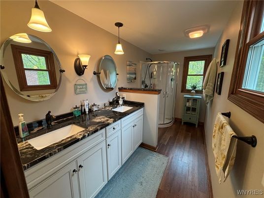 Bathroom, Dual Sink Vanities, Glass Shower, Interior, Pendant Lights, Wood Texture Flooring