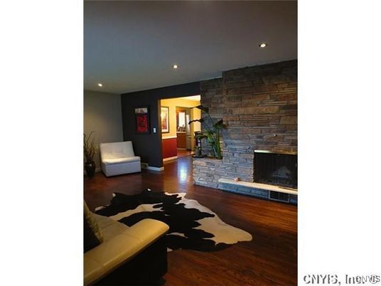Fireplace, Interior, Living room, Recessed Lighting, Stone Walls, Wood Texture Flooring