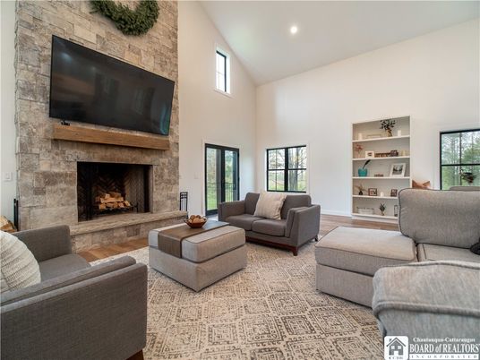 Fireplace, Interior, Living room, Recessed Lighting, Stone Walls, Wood Texture Flooring