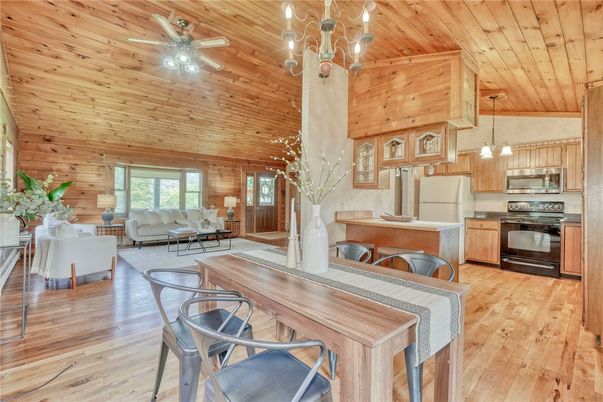 Chandelier, Dining room, Interior, Kitchen, Living room, Pendant Lights, Stainless Steel Appliances, Wooden Ceilings, Wood Texture Flooring, Wooden Walls