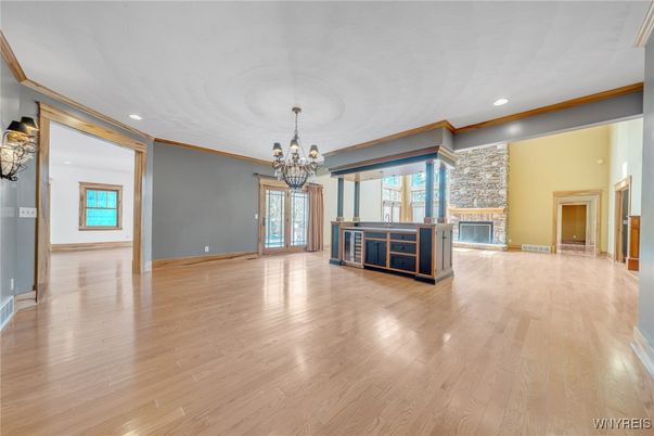 Chandelier, Empty room, Fireplace, Interior, Kitchen, Recessed Lighting, Wood Texture Flooring