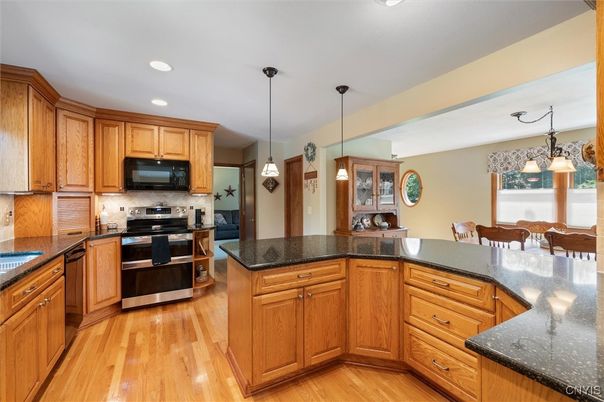 Dining room, Interior, Kitchen, Pendant Lights, Recessed Lighting, Stainless Steel Appliances, Wood Texture Flooring