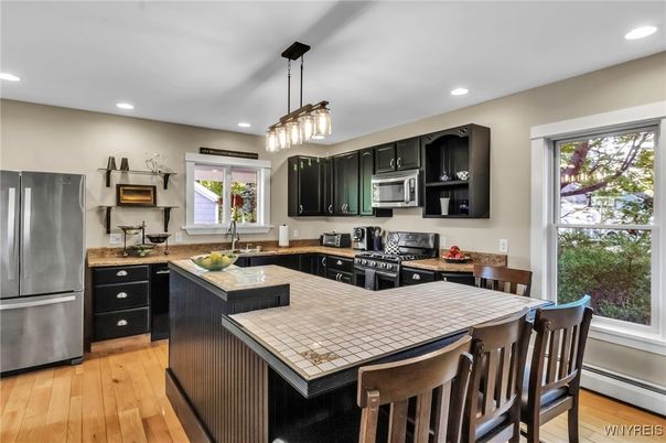 Interior, Kitchen, Pendant Lights, Recessed Lighting, Stainless Steel Appliances, Tile Countertops, Wood Texture Flooring