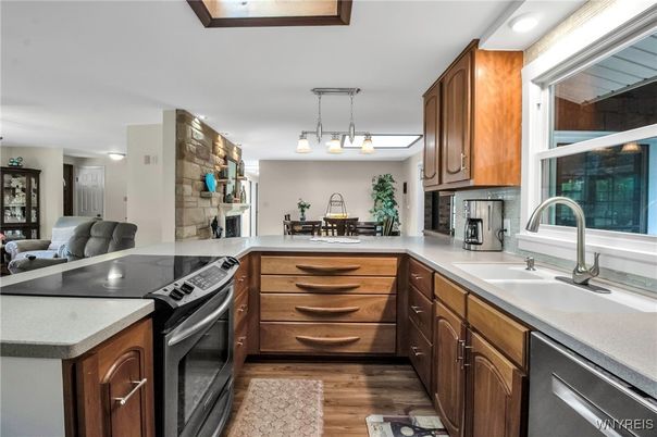 Dining room, Fireplace, Interior, Kitchen, Pendant Lights, Stainless Steel Appliances, Wood Texture Flooring