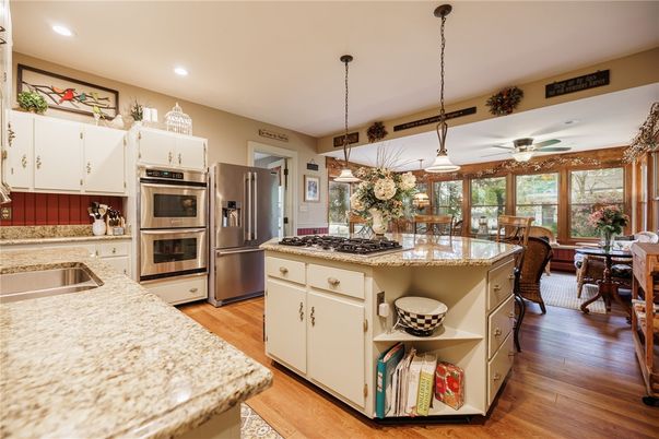 Dining room, Interior, Kitchen, Pendant Lights, Recessed Lighting, Stainless Steel Appliances, Wood Texture Flooring