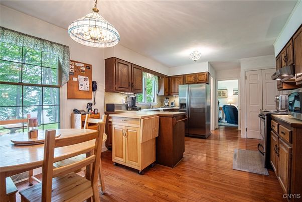 Chandelier, Dining room, Interior, Kitchen, Stainless Steel Appliances, Wood Texture Flooring