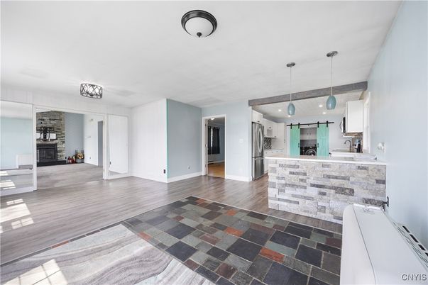 Fireplace, Interior, Kitchen, Pendant Lights, Stainless Steel Appliances, Stone Walls, Wood Texture Flooring
