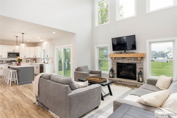 Fireplace, Interior, Kitchen, Living room, Pendant Lights, Recessed Lighting, Stainless Steel Appliances, Wood Texture Flooring