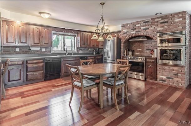 Dining room, Interior, Kitchen, Pendant Lights, Stainless Steel Appliances, Stone Walls, Wood Texture Flooring