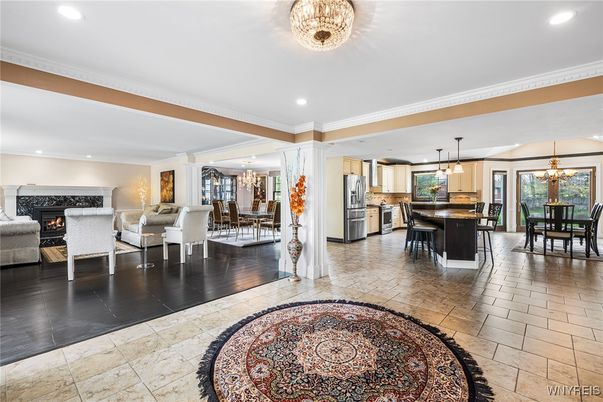 Chandelier, Dining room, Fireplace, Interior, Kitchen, Living room, Pendant Lights, Recessed Lighting, Stainless Steel Appliances, Wood Texture Flooring