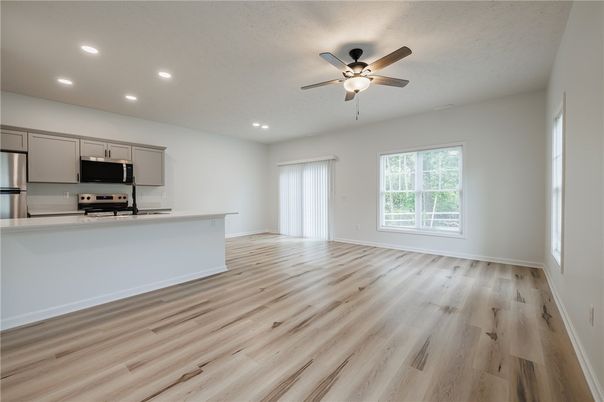 Empty room, Interior, Kitchen, Recessed Lighting, Stainless Steel Appliances, Wood Texture Flooring