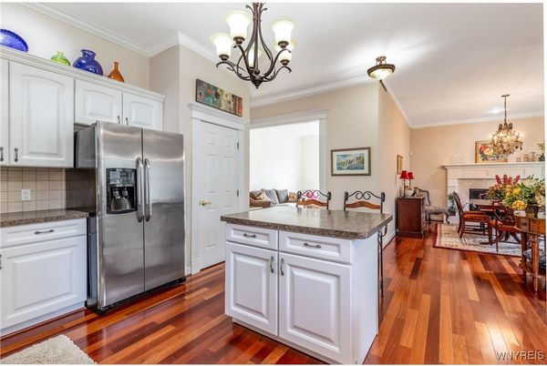 Chandelier, Dining room, Fireplace, Interior, Kitchen, Stainless Steel Appliances, Wood Texture Flooring