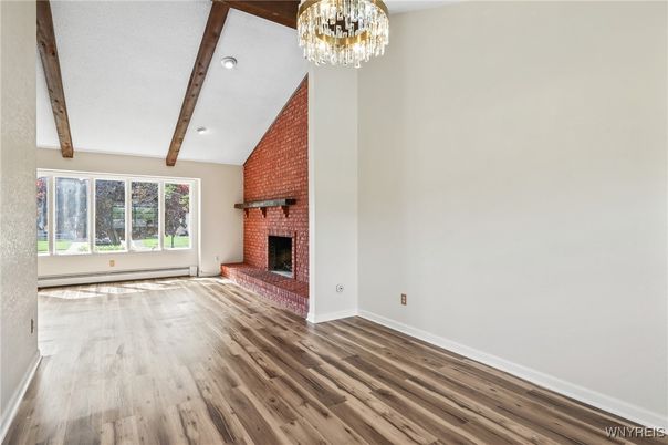 Chandelier, Empty room, Fireplace, Interior, Recessed Lighting, Stone Walls, Wooden Beams, Wood Texture Flooring