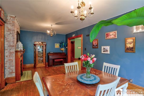 Chandelier, Dining room, Fireplace, Interior, Piano, Stone Walls, Wood Texture Flooring