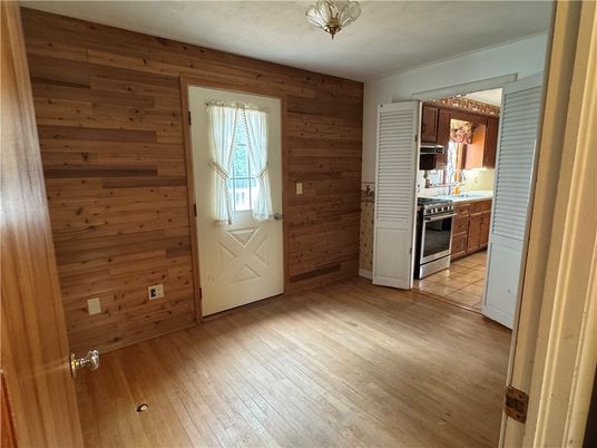 Empty room, Interior, Kitchen, Stainless Steel Appliances, Wood Texture Flooring, Wooden Walls