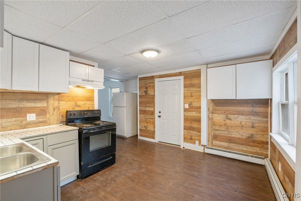 Interior, Kitchen, Tile Countertops, Wood Texture Flooring, Wooden Walls