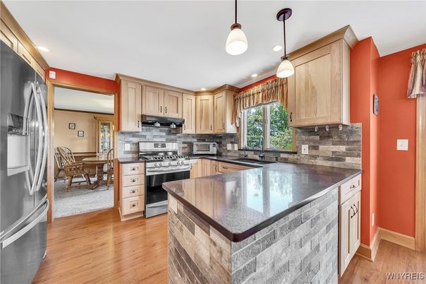 Dining room, Interior, Kitchen, Pendant Lights, Recessed Lighting, Stainless Steel Appliances, Wood Texture Flooring