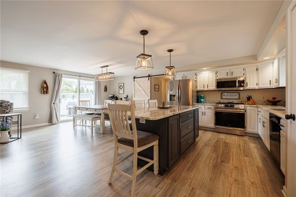Chandelier, Dining room, Interior, Kitchen, Pendant Lights, Recessed Lighting, Stainless Steel Appliances, Wood Texture Flooring