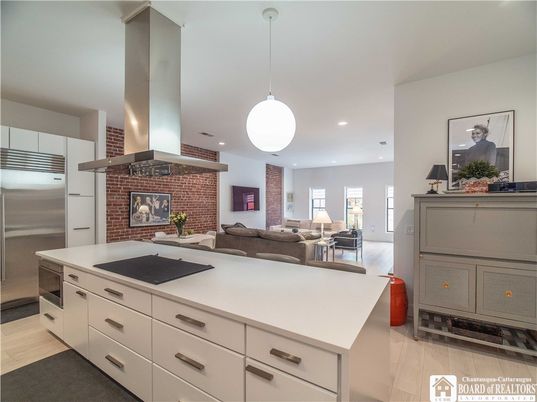 Fireplace, Interior, Kitchen, Living room, Pendant Lights, Recessed Lighting, Stainless Steel Appliances, Stone Walls, Wood Texture Flooring