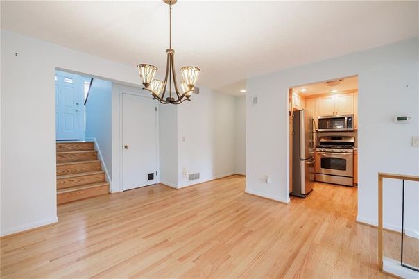 Chandelier, Empty room, Interior, Kitchen, Pendant Lights, Recessed Lighting, Stainless Steel Appliances, Wood Texture Flooring