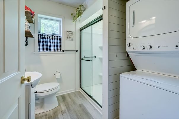 Bathroom, Glass Shower, Interior, Utility Closets, Washer, Wood Texture Flooring