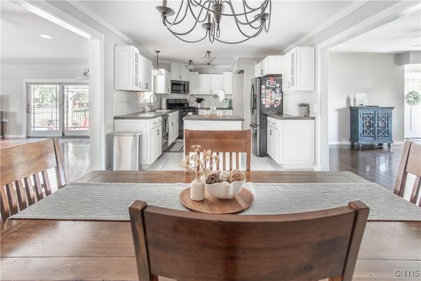 Chandelier, Dining room, Interior, Kitchen, Pendant Lights, Recessed Lighting, Stainless Steel Appliances, Wood Texture Flooring