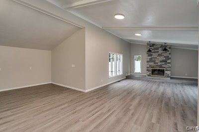 Empty room, Fireplace, Interior, Recessed Lighting, Stone Walls, Wood Texture Flooring