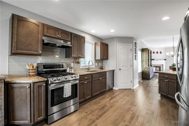 Fireplace, Interior, Kitchen, Pendant Lights, Recessed Lighting, Stainless Steel Appliances, Wood Texture Flooring