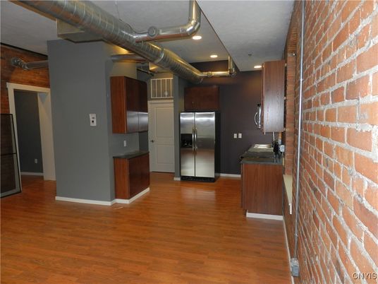 Elevator, Interior, Kitchen, Recessed Lighting, Stainless Steel Appliances, Stone Walls, Wood Texture Flooring