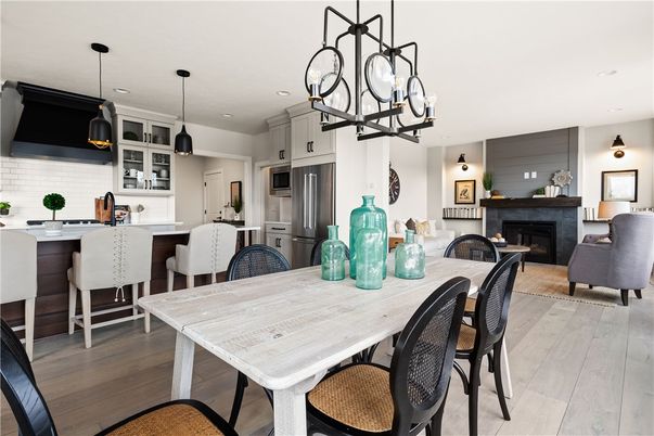 Chandelier, Dining room, Fireplace, Interior, Kitchen, Living room, Pendant Lights, Recessed Lighting, Stainless Steel Appliances, Wood Texture Flooring