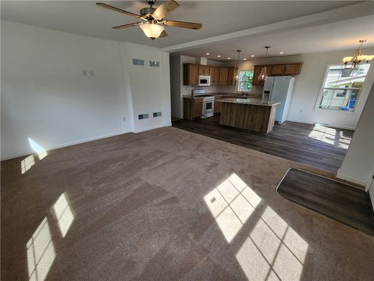 Empty room, Interior, Kitchen, Pendant Lights, Recessed Lighting, Stainless Steel Appliances, Wood Texture Flooring