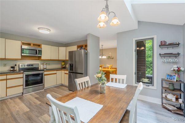 Chandelier, Dining room, Interior, Kitchen, Pendant Lights, Stainless Steel Appliances, Wood Texture Flooring