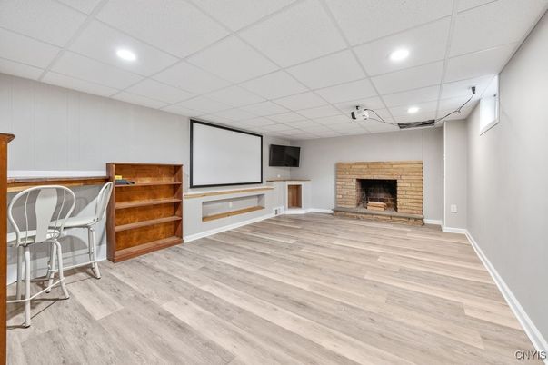 Empty room, Fireplace, Interior, Projection Screen, Recessed Lighting, Wood Texture Flooring