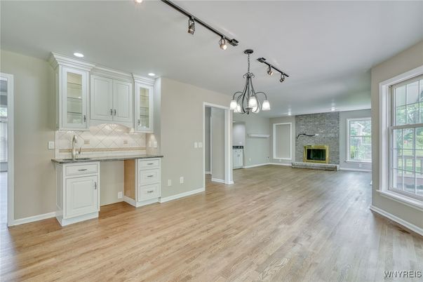 Chandelier, Empty room, Fireplace, Interior, Kitchen, Recessed Lighting, Stone Walls, Wood Texture Flooring